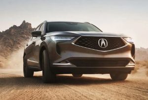 Close up view of the front of a 2023 Acura MDX driving outside of Indianapolis, Indiana