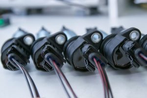 Four ignition coils laid out at a service center near Indianapolis, Indiana.