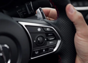 A close up image of a person holding the steering wheel of a 2024 Acura TLX near Indianapolis, Indiana