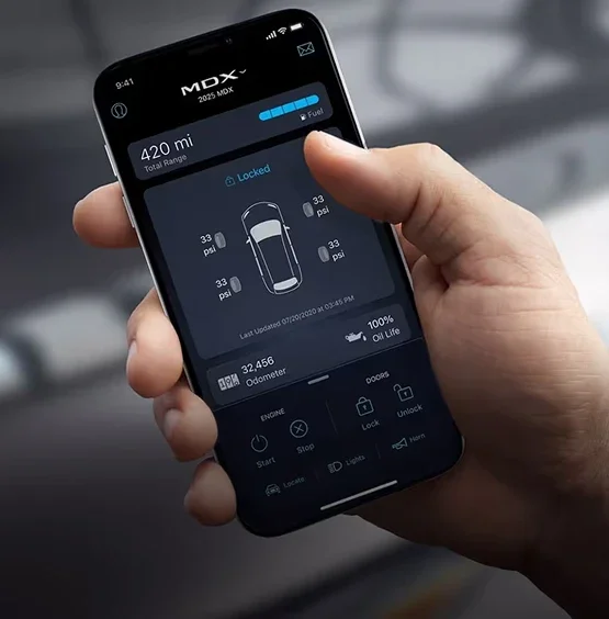 Hand holding a phone running the AcuraLink app, showing an MDX with its range, tyre pressures, odometer and remote lock controls