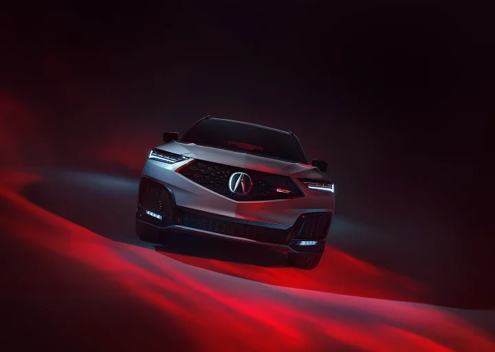 Acura MDX Type S shown head-on against red light trails